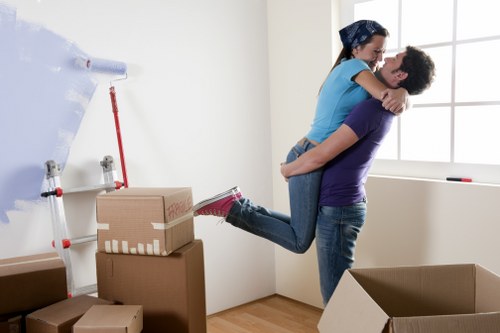 Team collecting old sofas, tables, and cabinets from a London property