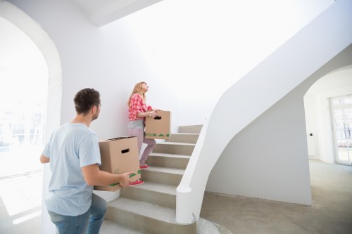 Removal team transporting furniture through a London building