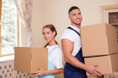 Student accommodation move with movers carrying furniture