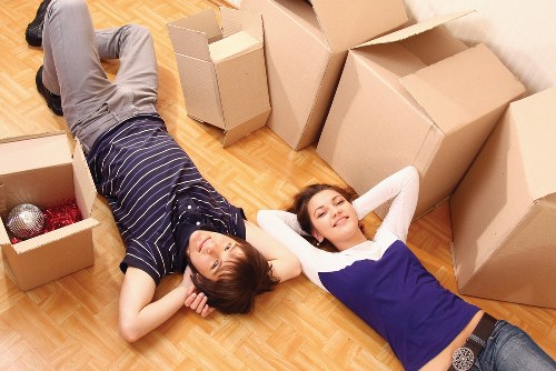 Piano movers protecting floors and walls during a London relocation