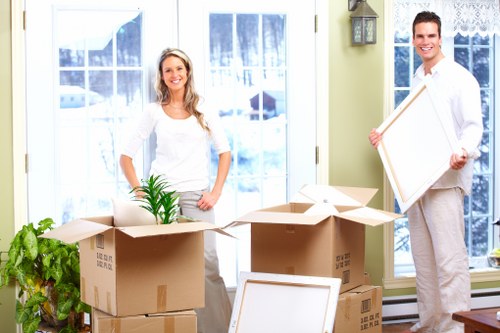 Trained removals staff carrying furniture with care